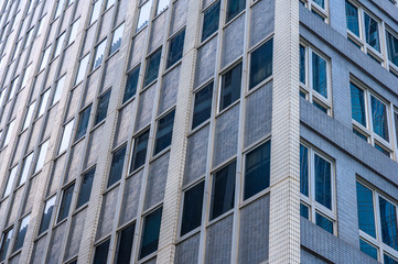 Panoramic and perspective wide angle view to steel blue background of glass high rise building skyscrapers in modern futuristic downtown
