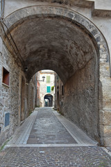 Guarcino, Italy, 01/03/2020. An alley between the old houses of a medieval village.