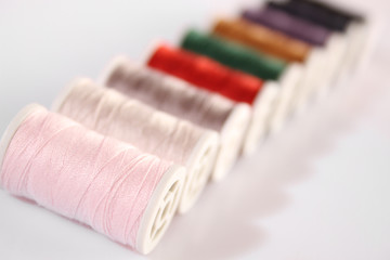 Fototapeta na wymiar Many multi-colored spools of thread