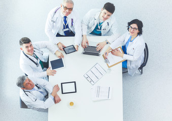 Fototapeta premium Medical team sitting and discussing at table, top view