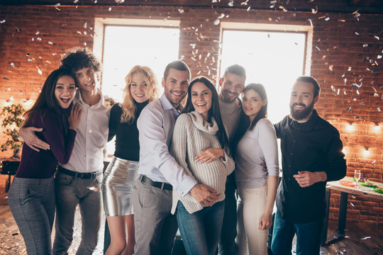 Photo of best friends celebrating surprise baby born occasion party greeting future young parents hugging making photos confetti falling formalwear restaurant indoors