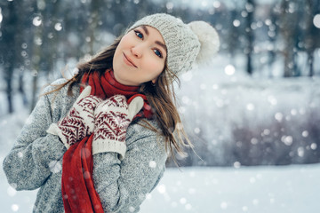 Winter young woman portrait. Beauty Joyful Model Girl laughing and having fun in winter park. Beautiful young female outdoors, Enjoying nature, wintertime