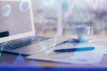 Obraz premium Forex graph hologram on table with computer background. Double exposure. Concept of financial markets.