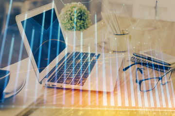 Forex market graph hologram and personal computer on background. Double exposure. Concept of investment.
