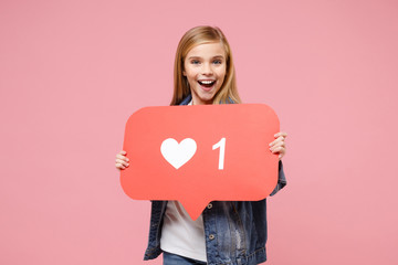 Excited little kid girl 12-13 years old in denim jacket isolated on pastel pink background in...