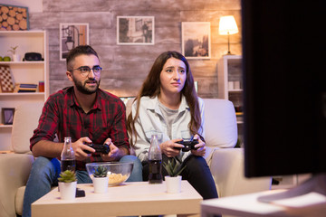 Couple enjoying their time together while playing video games