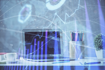 Stock market chart hologram drawn on personal computer background. Double exposure. Concept of investment.