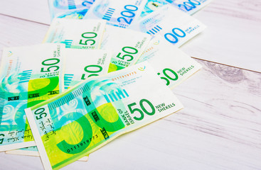 Israely Shekel money bills collection background.