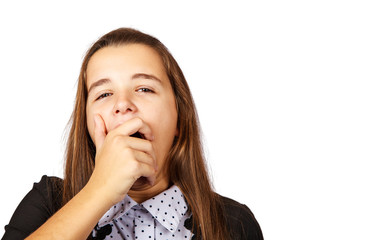 teen girl yawns covering her mouth with her hand