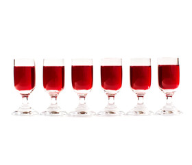 Set of alcoholic cherry cocktails in shot glasses isolated on white