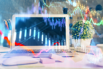 Financial chart drawing and table with computer on background. Multi exposure. Concept of international markets.