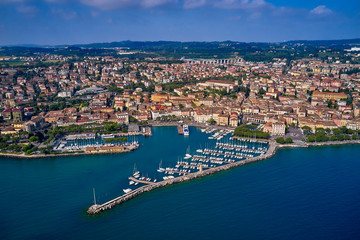 Aerial view of the city center of Desenzano del Garda, Italy. The main lighthouse of the city, boat parking in the city center.