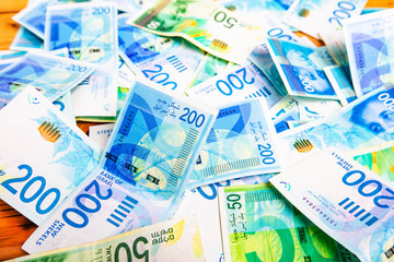 Israely Shekel money bills collection background.