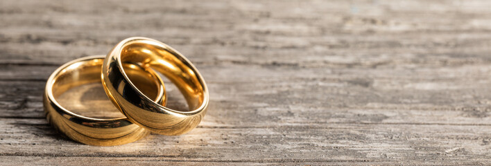 Golden wedding rings on wood - 315319272