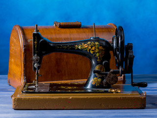 Close-up of an old sewing machine, on a wooden table