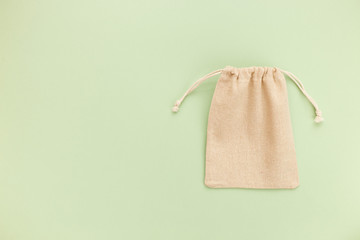 Canvas bag with drawstring, mockup of small eco sack made from natural cotton fabric cloth flat lay...