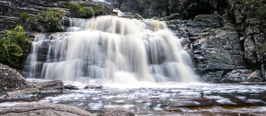 Obraz premium Close up of a beautiful waterfall with water motion blur and pond, Caraca natural park, Minas Gerais, Brazil