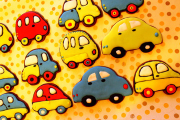 Many colorful gingerbread cookies covered with glaze. Background. Toy car