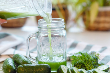 the process of making fresh juice or cucumber smoothies, detox smoothies and juices, weight loss diet