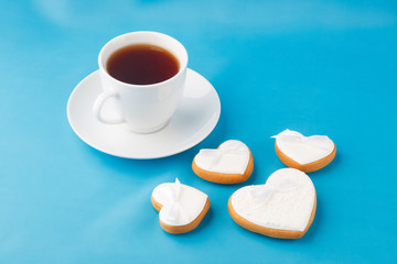 Obraz na płótnie Canvas Heart-shaped cookies and a cup of tea for Valentine's Day