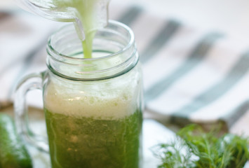 the process of making fresh juice or cucumber smoothies, detox smoothies and juices, weight loss diet