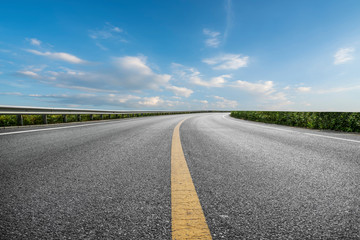 Skyline of Asphalt Pavement and Blue Sky and White Cloud