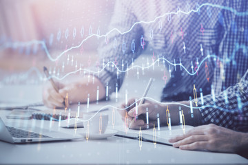 Multi exposure of forex chart with man working on computer on background. Concept of market analysis.