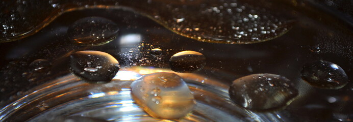 Oil bubbles in water close up.