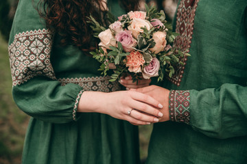 bride and groom holding wedding bouquet