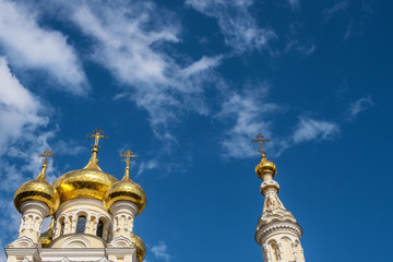 Fototapeta na wymiar Golden domes of the Cathedral of St. Alexander Nevsky against the sky.