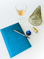 New Year's Resolutions for the New Year 2020 Notebook with Ready Pen, New Goals and Commitments and Promises Christmas Holiday Decorations Warm Tea and New Year Events, Golden Tree wine glass planning © Martin