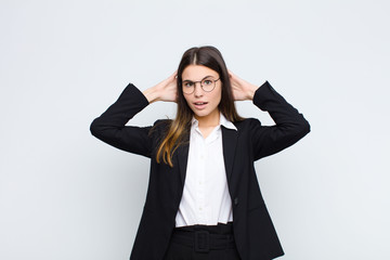 young businesswoman feeling stressed, worried, anxious or scared, with hands on head, panicking at...