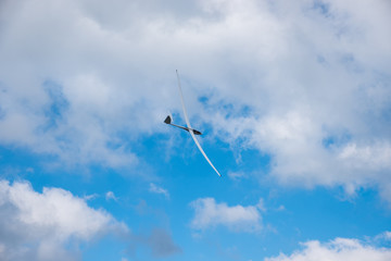 Fototapeta na wymiar sailplane in the sky, with cumulus clouds