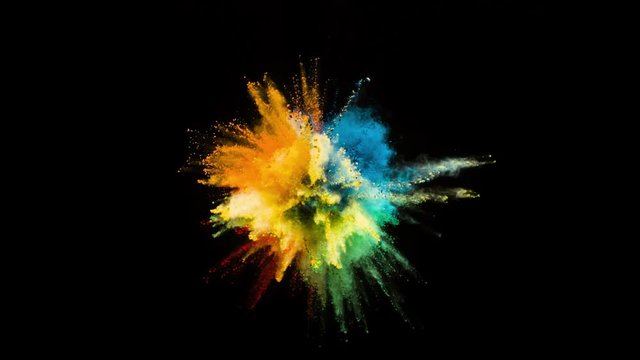 Colored powder explosion, abstract close up dust isolated on black background in slow motion