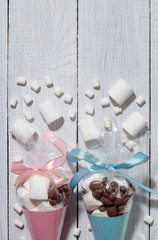 Holiday gifts of sweets and marshmallows packed in blue and pink cones