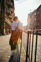 portrait of pretty woman on sunset at city street