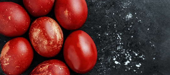 Greeting card with easter eggs painted in monochrome red shiny dye style on black background with...