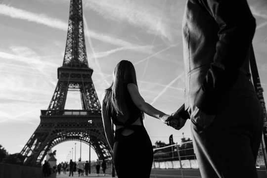 Romantic date, honeymoon, travel, marriage proposal in Paris. Couple in love walking near the Eiffel tower