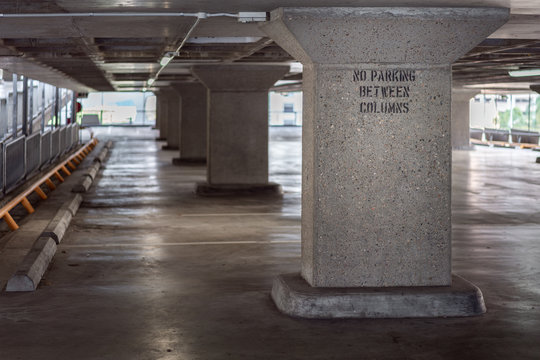 No Parking Between Columns Sign Inside Empty Urban Car Park