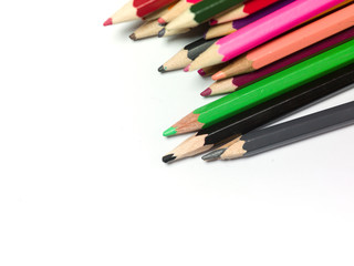 various colors of pencils on a white background, copy space