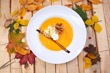 pumpkin cream soup on the wooden background