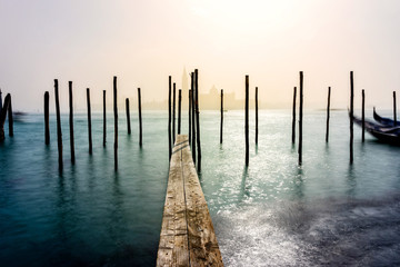 San Giorgio Maggiore church and wooden pier in Venice during a misty/foggy spring day, Venice,...