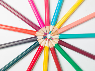 various colors of pencils on a white background, copy space
