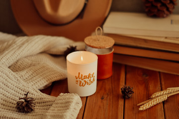 still life with candle, books and hat