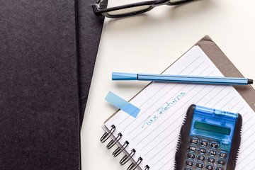 Fototapeta premium Calculating tax return numbers and figures on office desk concept for filling tax return forms