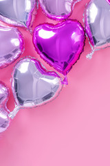 Valentine's Day romantic design concept - Beautiful real heart shape foil balloon isolated on pale pink background, top view, flat lay, overhead above photography.