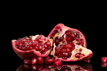 slices of red pomegranate fruit and haze of water on a black background