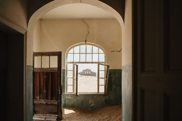 Old abandoned industrial building slowly filled with sand