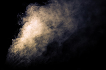 Jet of smoke on black background. Selective focus. Toned
