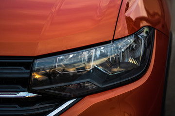 Close up photo of modern and clean car, detail of headlight. Headlight car Projector/LED of a...